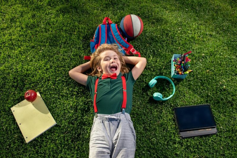 excited kid learn online virtual school using tablet green grass outdoors elearning happy boy relaxing grass 265223 39902 scaled