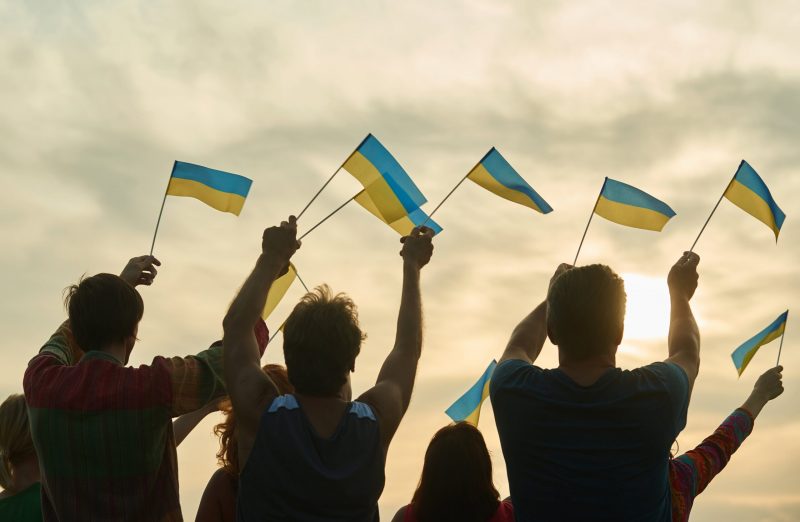 young people waving ukraininan flags back view 2021 09 14 16 12 16 utc scaled 1 scaled